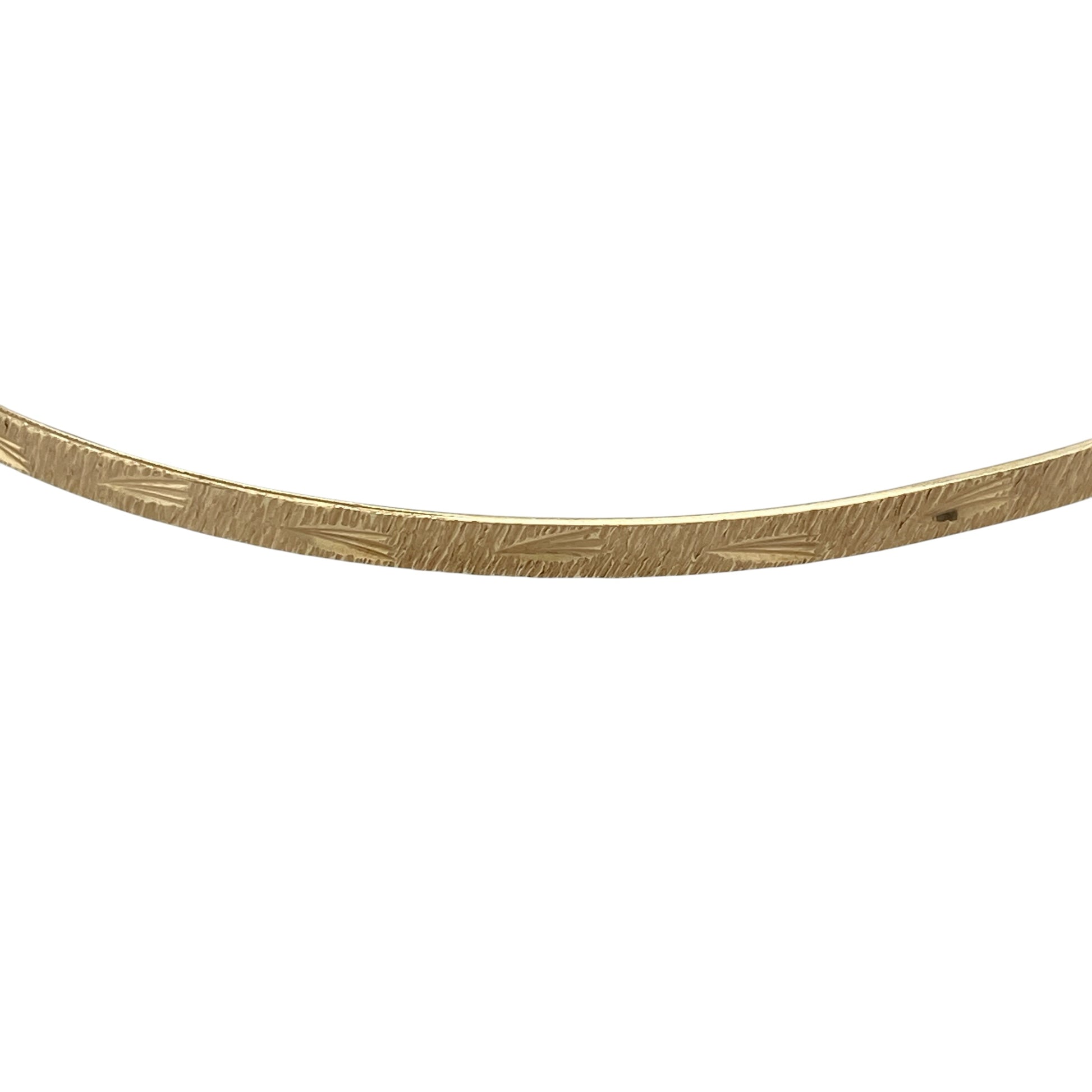Add timeless elegance and decorative detail to your jewellery collection with this pre-owned 9ct yellow solid gold patterned bangle, featuring a classic slim profile with an attractive textured finish.

Design: The bangle showcases a traditional round profile enhanced with decorative patterning, creating additional texture and visual interest while retaining the timeless appeal of classic gold jewellery.