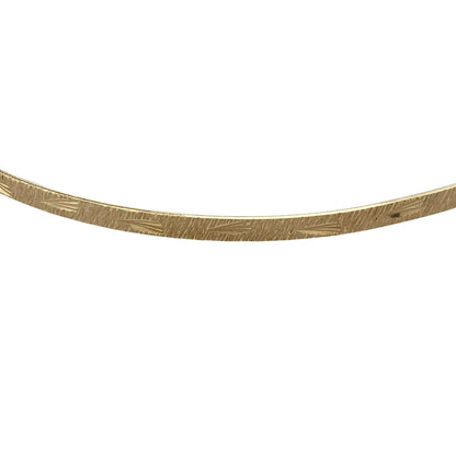 Add timeless elegance and decorative detail to your jewellery collection with this pre-owned 9ct yellow solid gold patterned bangle, featuring a classic slim profile with an attractive textured finish.

Design: The bangle showcases a traditional round profile enhanced with decorative patterning, creating additional texture and visual interest while retaining the timeless appeal of classic gold jewellery.