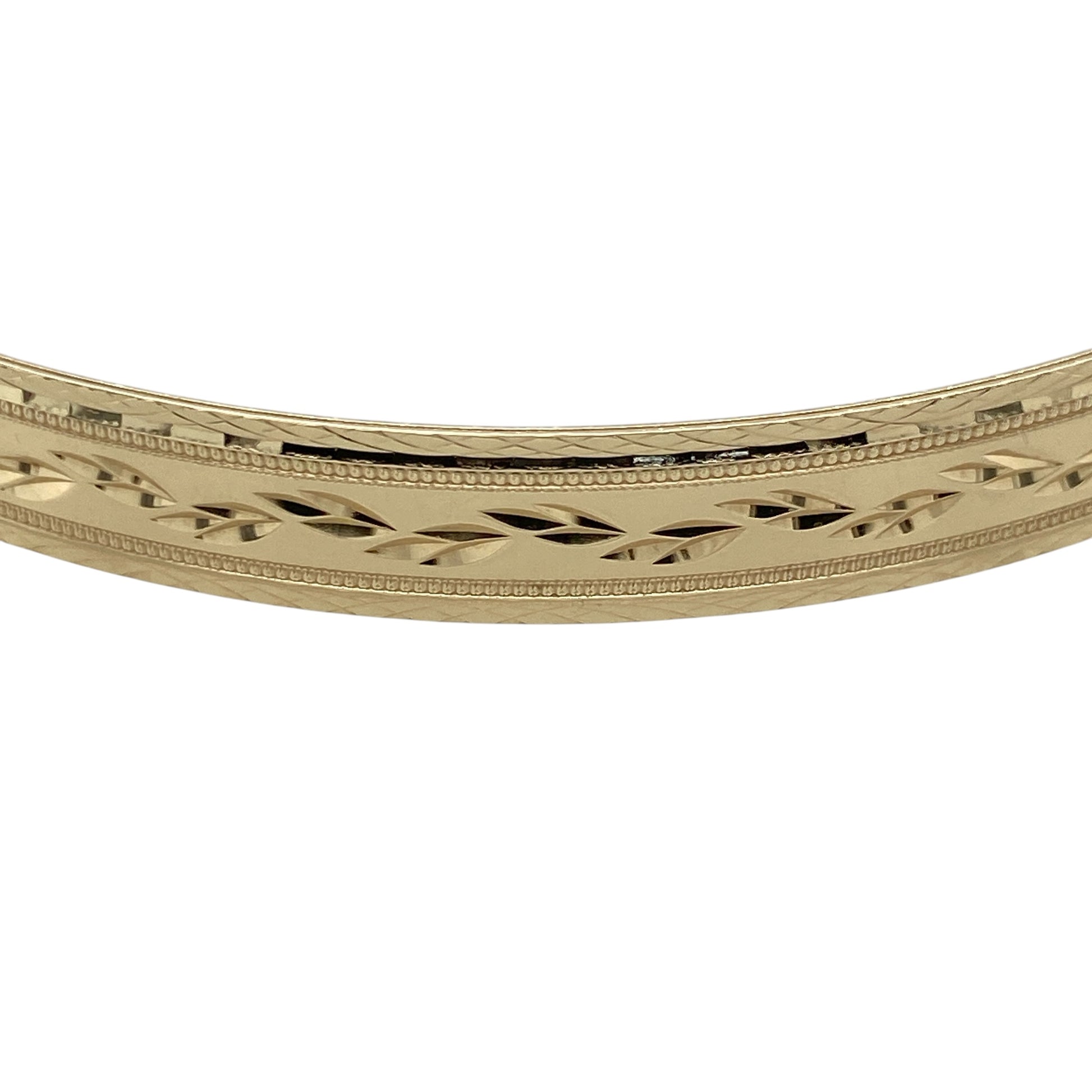 Add timeless elegance and decorative detail to your jewellery collection with this pre-owned 9ct yellow solid gold patterned bangle, featuring a substantial profile with an attractive textured finish.

Design: The bangle showcases a traditional round profile enhanced with decorative patterning, creating additional texture and visual interest while retaining the timeless appeal of classic gold jewellery.