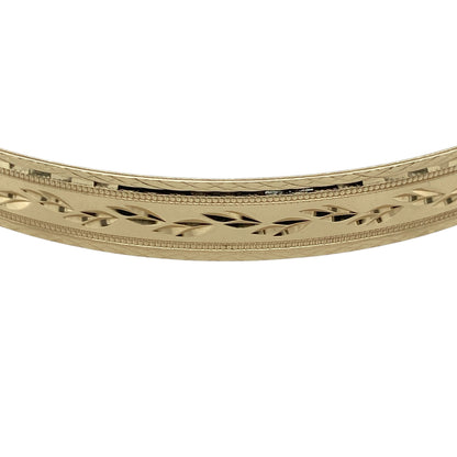 Add timeless elegance and decorative detail to your jewellery collection with this pre-owned 9ct yellow solid gold patterned bangle, featuring a substantial profile with an attractive textured finish.

Design: The bangle showcases a traditional round profile enhanced with decorative patterning, creating additional texture and visual interest while retaining the timeless appeal of classic gold jewellery.
