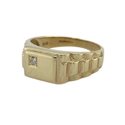 Add distinctive styling and subtle sparkle to your jewellery collection with this pre-owned 9ct yellow gold and diamond watch strap style signet ring, featuring unusual shoulder detailing and a bold, characterful design.

Design: The ring showcases a distinctive signet-style profile enhanced with watch strap inspired shoulders, creating an unusual and eye-catching appearance complemented by diamond detailing.