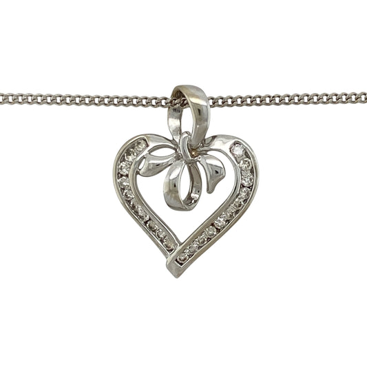 Add romantic styling and elegant sparkle to your jewellery collection with this pre-owned 9ct white gold and diamond open heart bow pendant necklace, featuring a decorative design suspended from a classic curb chain.

Design: The pendant showcases an elegant open heart profile enhanced with a bow-inspired design and diamond detailing, creating a romantic and decorative appearance with timeless appeal.