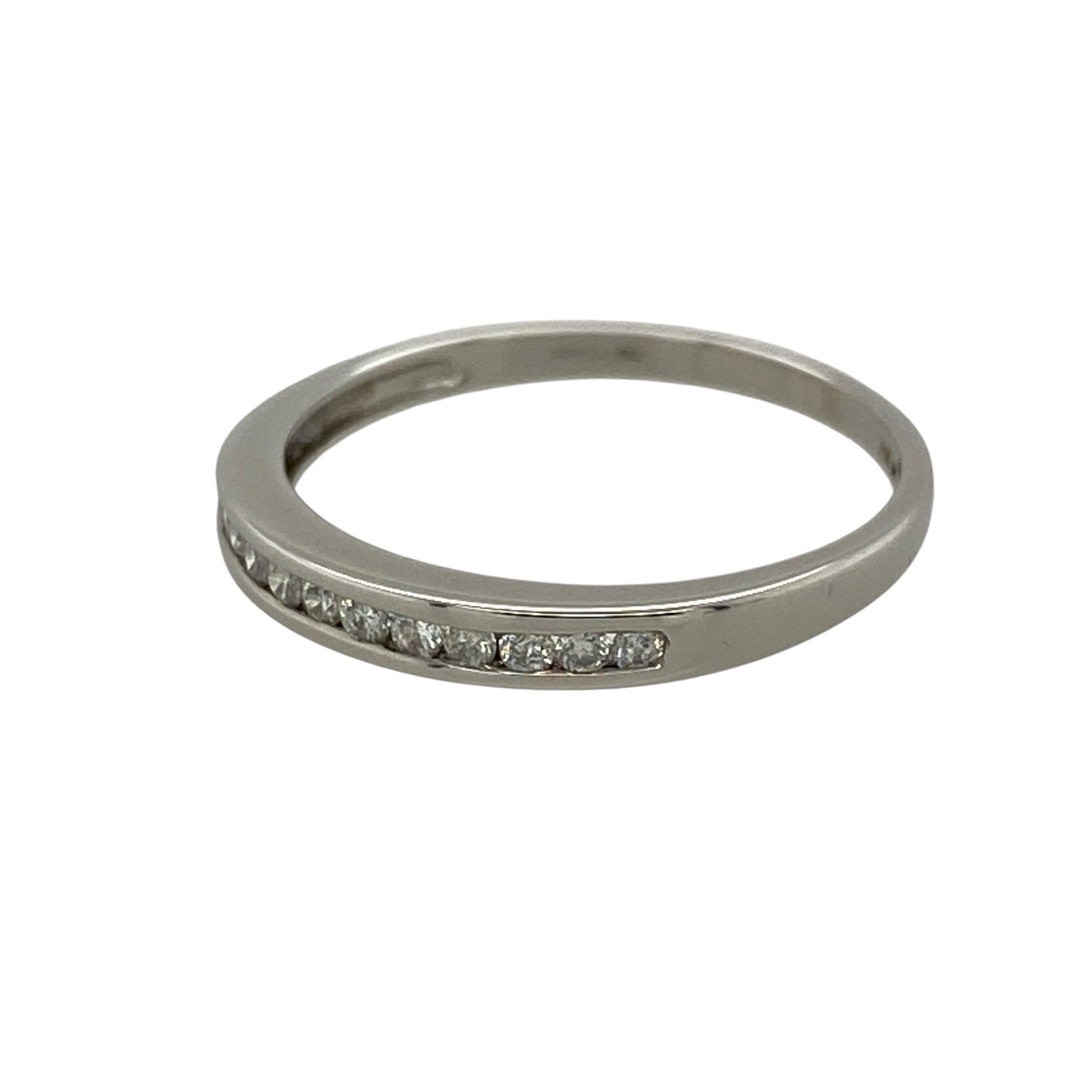 Add refined sparkle and timeless elegance to your jewellery collection with this pre-owned 9ct white gold and diamond band ring, featuring a slim profile and approximately 0.15ct of diamond content—perfect as a diamond wedding band, eternity-style ring, stacking ring, or elegant everyday piece.

Design: The ring features a classic slim band design accented with sparkling diamonds across the front, creating an understated and elegant appearance that can be worn alone or paired with other rings.