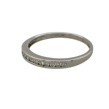 Add refined sparkle and timeless elegance to your jewellery collection with this pre-owned 9ct white gold and diamond band ring, featuring a slim profile and approximately 0.15ct of diamond content—perfect as a diamond wedding band, eternity-style ring, stacking ring, or elegant everyday piece.

Design: The ring features a classic slim band design accented with sparkling diamonds across the front, creating an understated and elegant appearance that can be worn alone or paired with other rings.