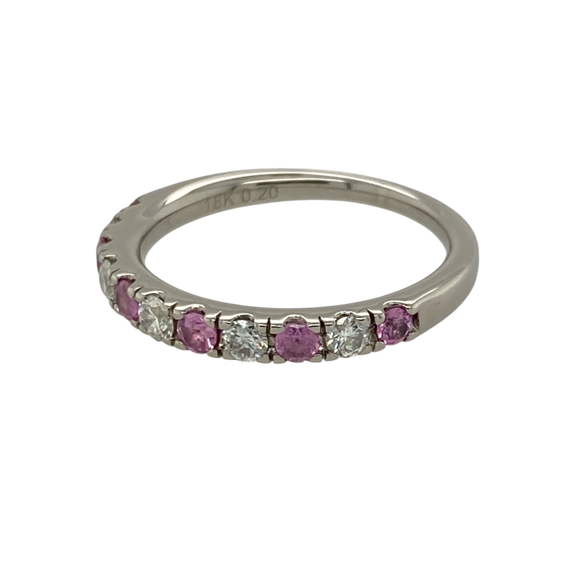 Add vibrant colour and luxurious sparkle to your jewellery collection with this pre-owned 18ct white gold diamond and pink sapphire band ring, featuring delicate pink gemstones and approximately 0.20ct of total diamond content—perfect as an anniversary ring, wedding band, stacking ring, or elegant piece for special occasions.

Design: The ring features an elegant band design combining round pink sapphire stones with sparkling diamonds, creating an eye-catching contrast of soft pink colour