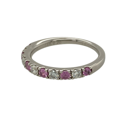 Add vibrant colour and luxurious sparkle to your jewellery collection with this pre-owned 18ct white gold diamond and pink sapphire band ring, featuring delicate pink gemstones and approximately 0.20ct of total diamond content—perfect as an anniversary ring, wedding band, stacking ring, or elegant piece for special occasions.

Design: The ring features an elegant band design combining round pink sapphire stones with sparkling diamonds, creating an eye-catching contrast of soft pink colour