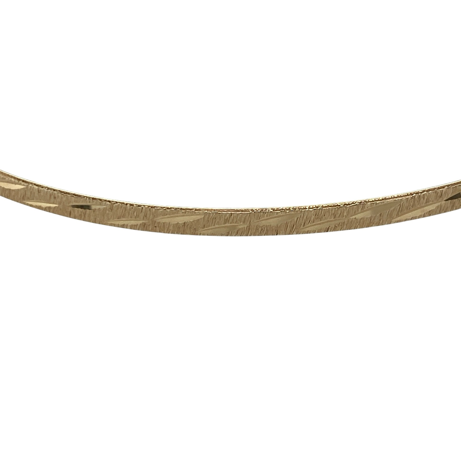 Add timeless elegance and classic style to your jewellery collection with this pre-owned 9ct solid yellow gold patterned bangle, featuring an attractive decorative finish and a slim, versatile profile—perfect for everyday wear, stacking with other bangles, or adding a touch of sophistication to any outfit.

Design: The bangle features a classic round profile with an attractive patterned finish, creating a timeless look that adds texture and subtle detail while remaining elegant and easy to wear.