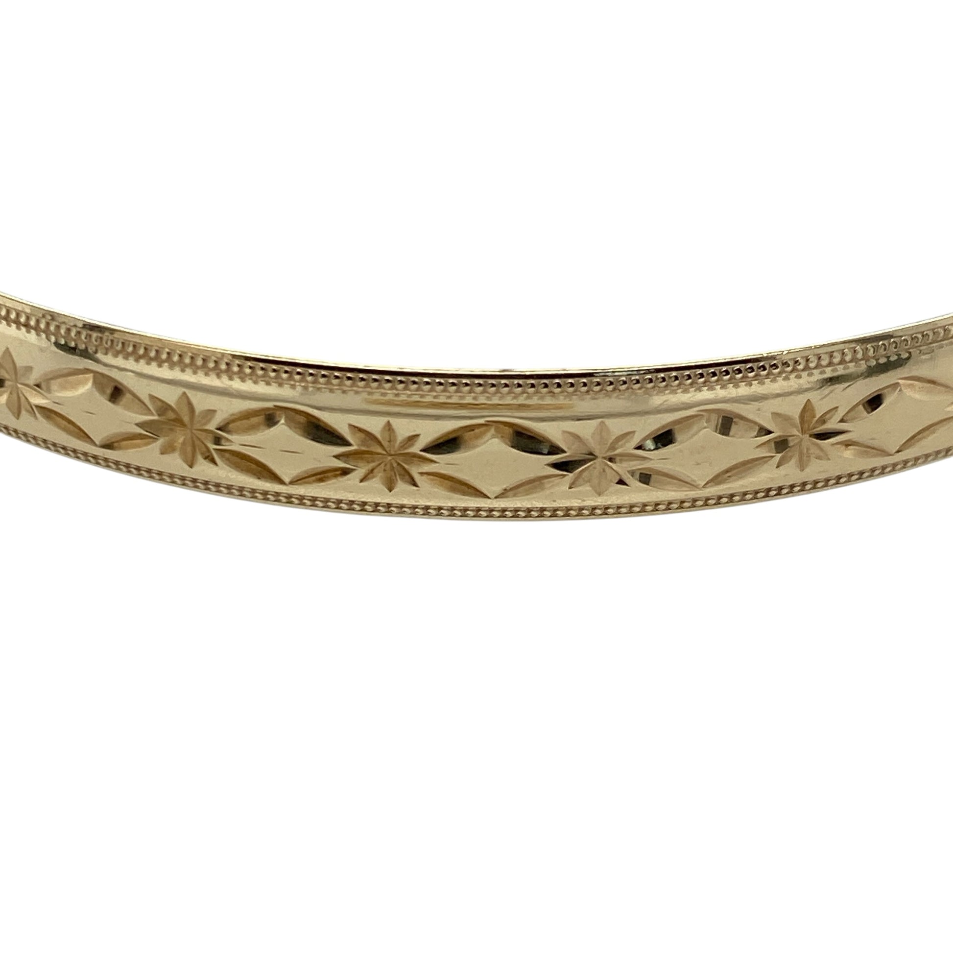 Add timeless elegance and classic style to your jewellery collection with this pre-owned 9ct solid yellow gold patterned bangle, featuring an attractive decorative finish and a substantial 6mm profile—perfect for everyday wear, special occasions, or as a statement addition to any fine jewellery collection.

Design: The bangle features a classic round profile with an elegant patterned finish, creating a timeless look with beautiful texture and decorative detail
