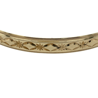 Add timeless elegance and classic style to your jewellery collection with this pre-owned 9ct solid yellow gold patterned bangle, featuring an attractive decorative finish and a substantial 6mm profile—perfect for everyday wear, special occasions, or as a statement addition to any fine jewellery collection.

Design: The bangle features a classic round profile with an elegant patterned finish, creating a timeless look with beautiful texture and decorative detail