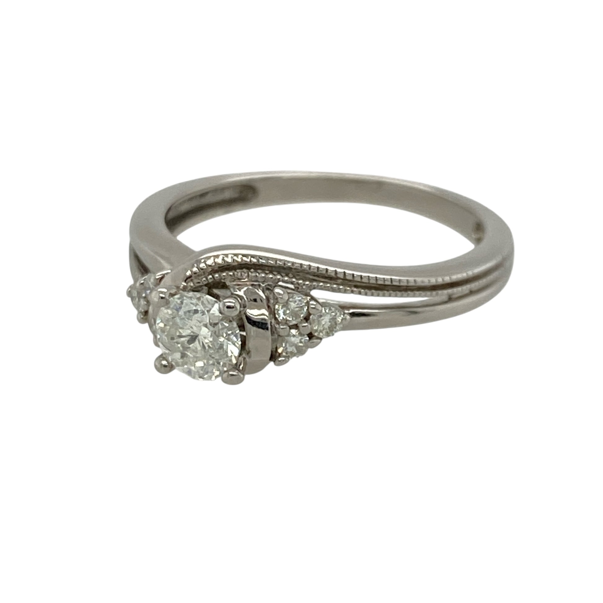 Add vintage-inspired elegance and timeless sparkle to your jewellery collection with this pre-owned 9ct white gold diamond milgrain detail twist solitaire ring, featuring approximately 0.30ct of total diamond content in an elegant twisted design—perfect as an engagement ring, anniversary gift, or sophisticated everyday jewellery piece.

Design: The ring features a classic solitaire design with beautifully twisted shoulders and delicate milgrain detailing, creating a timeless vintage-inspired look