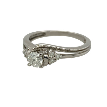 Add vintage-inspired elegance and timeless sparkle to your jewellery collection with this pre-owned 9ct white gold diamond milgrain detail twist solitaire ring, featuring approximately 0.30ct of total diamond content in an elegant twisted design—perfect as an engagement ring, anniversary gift, or sophisticated everyday jewellery piece.

Design: The ring features a classic solitaire design with beautifully twisted shoulders and delicate milgrain detailing, creating a timeless vintage-inspired look