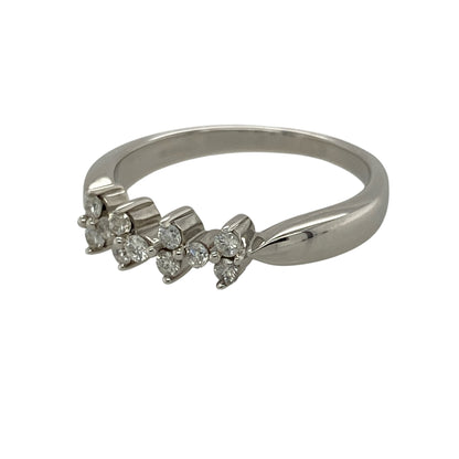 Add contemporary elegance and understated sparkle to your jewellery collection with this pre-owned 9ct white gold diamond scatter style band ring, featuring eleven brilliant-cut diamonds arranged across a wide band for a modern and eye-catching finish—perfect as a dress ring, anniversary gift, or stylish everyday jewellery piece.

Design: The ring features a contemporary scatter style design with eleven brilliant-cut diamonds positioned across the front of the band, creating a beautifully balanced look