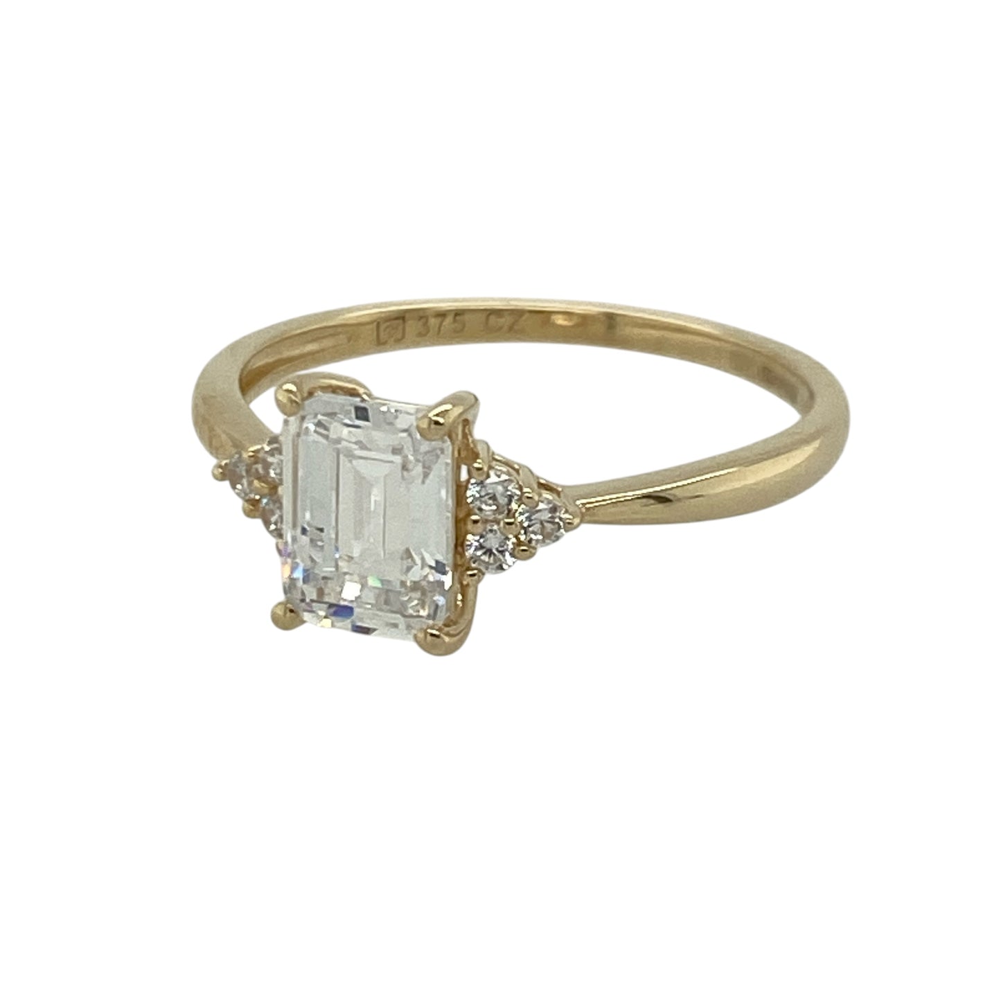 Bring classic elegance and eye-catching sparkle to your jewellery collection with this pre-owned 9ct yellow gold cubic zirconia solitaire ring, featuring a rectangular centre stone with smaller cubic zirconia clusters on each shoulder—perfect as a dress ring, engagement-style ring, or thoughtful gift.

Design: The ring features a rectangular solitaire-style centre stone, complemented by a small cluster of cubic zirconia stones on either side for added sparkle and a beautifully balanced finish.