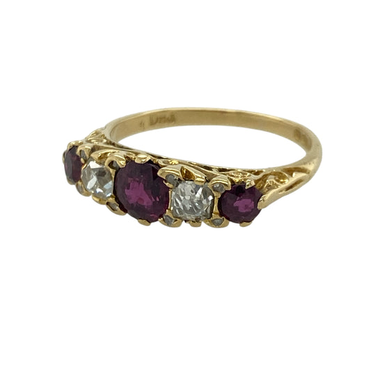 Add timeless elegance to your jewellery collection with this pre-owned 18ct yellow gold diamond and ruby five stone band ring. Featuring a striking round ruby at its centre, accented by vibrant rubies and sparkling diamonds, this classic ring is perfect for both everyday wear and special occasions.

Design: The ring showcases a traditional five stone band design with a vibrant round ruby at its centre, complemented by alternating rubies and diamonds for a timeless and elegant finish.