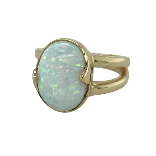 Make a statement with this eye-catching pre-owned 14ct yellow gold Opalique dress ring. Featuring a large oval Opalique stone with its beautiful iridescent appearance, this elegant ring is perfect for adding a touch of vintage charm to both everyday and occasion wear.

Design: The ring showcases a striking oval Opalique stone in a classic dress ring setting, allowing the colourful stone to take centre stage.