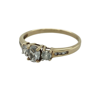 Elegant and timeless, this pre-owned 9ct yellow gold blue topaz and cubic zirconia trilogy ring is a beautiful choice for everyday wear or a thoughtful gift. The vibrant blue topaz is perfectly complemented by sparkling cubic zirconia stones, creating a classic trilogy design full of colour and brilliance. Blue topaz is the birthstone for December, making this ring an ideal gift for a December birthday.