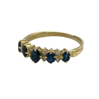 Add timeless elegance to your jewellery collection with this pre-owned 18ct yellow gold diamond and sapphire band ring, beautifully set with graduating sapphires and sparkling diamonds.

Design: This elegant band ring features a striking oval sapphire at the centre, flanked by graduating sapphires with sparkling diamonds set between each gemstone. The balanced design creates a sophisticated look that is perfect for everyday wear or special occasions.