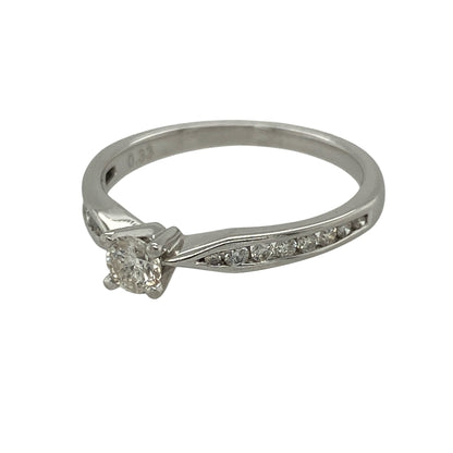 This pre-owned platinum diamond solitaire ring combines a striking princess cut centre diamond with sparkling brilliant cut shoulder diamonds, creating a timeless engagement ring with elegant modern styling.

Design: The ring features a beautiful princess cut diamond at its centre, complemented by brilliant cut diamonds set into the shoulders for added sparkle and a refined finish. Its classic solitaire design with diamond-set shoulders offers a sophisticated look that never goes out of style.