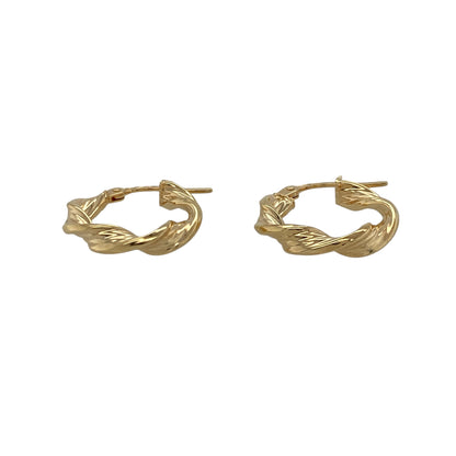 These pre-owned 9ct yellow gold twisted hoop creole earrings offer a timeless look with an elegant twisted finish, making them perfect for everyday wear.

Design: The earrings feature a classic creole hoop design with a polished twisted pattern that catches the light beautifully. Their compact size makes them comfortable to wear while adding a touch of style to any outfit.
Material: Made from 9-carat yellow gold.