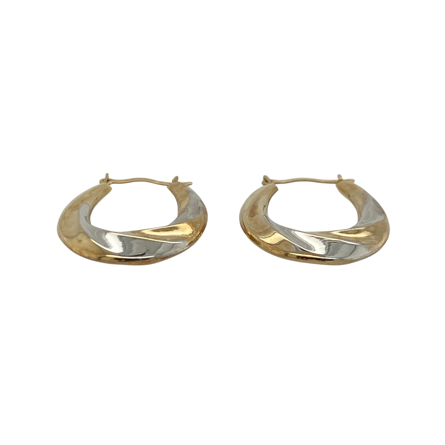 These pre-owned 9ct yellow and white gold twisted oval creole earrings combine two-tone gold with an elegant twisted design, making them a stylish addition to any jewellery collection.

Design: The earrings feature an attractive oval creole shape with intertwined yellow and white gold, creating a striking two-tone effect that complements both gold and silver jewellery. Their twisted finish adds texture and catches the light beautifully.
Material: Made from 9-carat yellow and white gold.