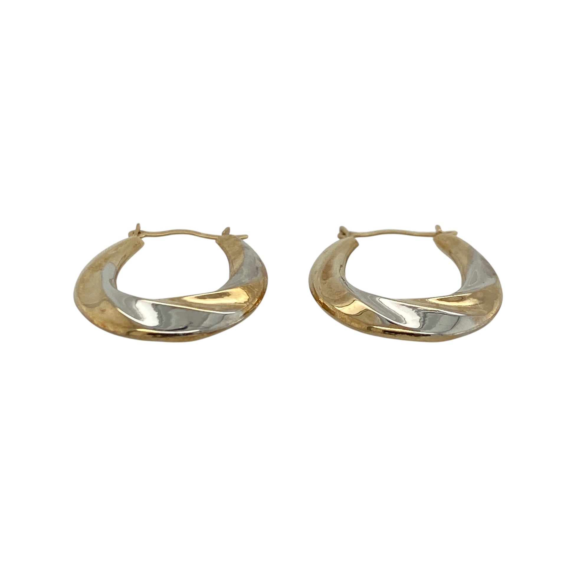These pre-owned 9ct yellow and white gold twisted oval creole earrings combine two-tone gold with an elegant twisted design, making them a stylish addition to any jewellery collection.

Design: The earrings feature an attractive oval creole shape with intertwined yellow and white gold, creating a striking two-tone effect that complements both gold and silver jewellery. Their twisted finish adds texture and catches the light beautifully.
Material: Made from 9-carat yellow and white gold.