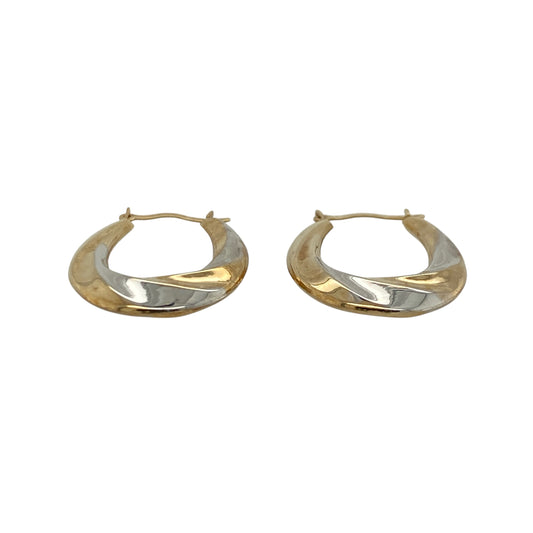 These pre-owned 9ct yellow and white gold twisted oval creole earrings combine two-tone gold with an elegant twisted design, making them a stylish addition to any jewellery collection.

Design: The earrings feature an attractive oval creole shape with intertwined yellow and white gold, creating a striking two-tone effect that complements both gold and silver jewellery. Their twisted finish adds texture and catches the light beautifully.
Material: Made from 9-carat yellow and white gold.