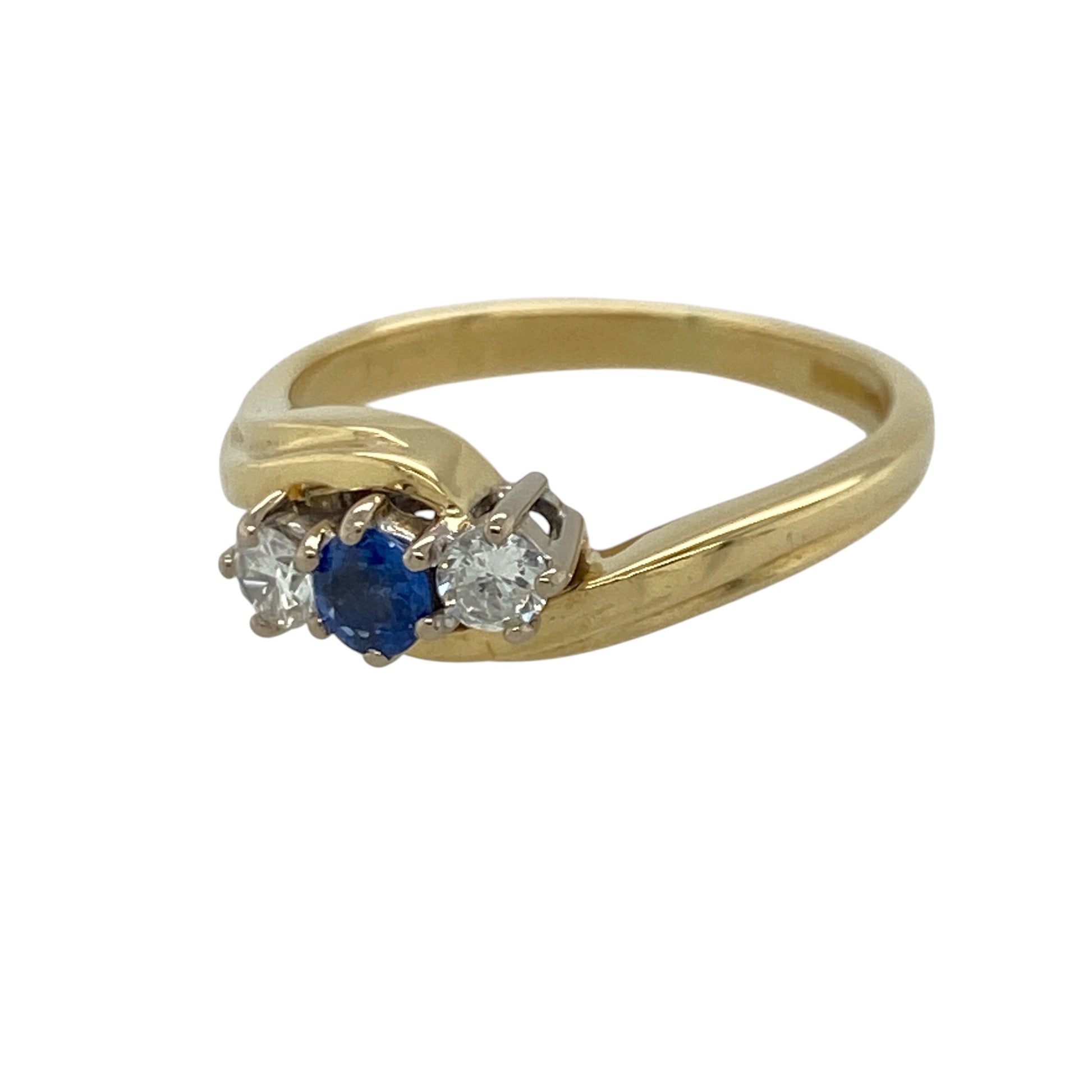 This pre-owned 18ct yellow gold diamond and sapphire trilogy twist ring is a timeless design, combining a rich blue sapphire with sparkling diamonds in an elegant twisted setting.

Design: The ring features a round centre sapphire with a brilliant diamond on either side, all held within a graceful twist design that enhances the classic trilogy style. The combination of deep blue sapphire and bright diamonds creates a sophisticated look suitable for any occasion.