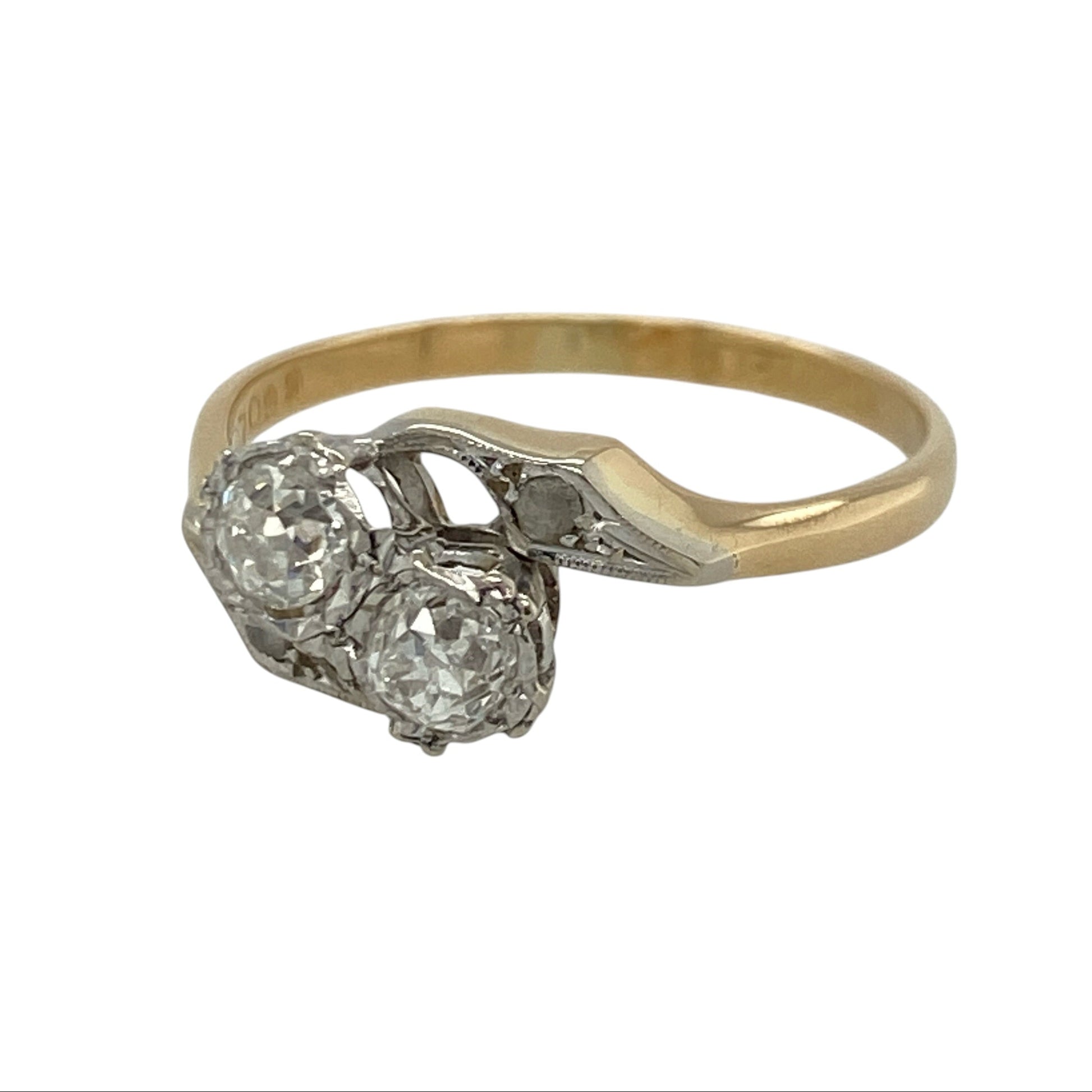 This pre-owned 18ct yellow gold and platinum old cut diamond twist ring is a timeless vintage design, beautifully showcasing the character and charm of old cut diamonds.

Design: The ring features a classic twist setting in rich 18-carat yellow gold with a platinum top, highlighting two beautiful old cut diamonds. The elegant crossover design gives the ring a graceful appearance while allowing the diamonds to catch the light from every angle.
Material: Made from 18-carat yellow gold with a platinum setting.