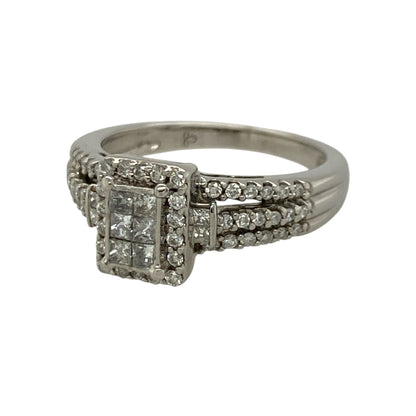This pre-owned 18ct white gold diamond rectangle cluster ring is an elegant statement piece, beautifully combining brilliant and princess cut diamonds in a timeless design.

Design: The ring features a striking rectangular cluster with a mix of brilliant and princess cut diamonds, creating a captivating display of sparkle and depth. Set in polished 18-carat white gold, it is a sophisticated piece that's perfect for both everyday wear and special occasions.