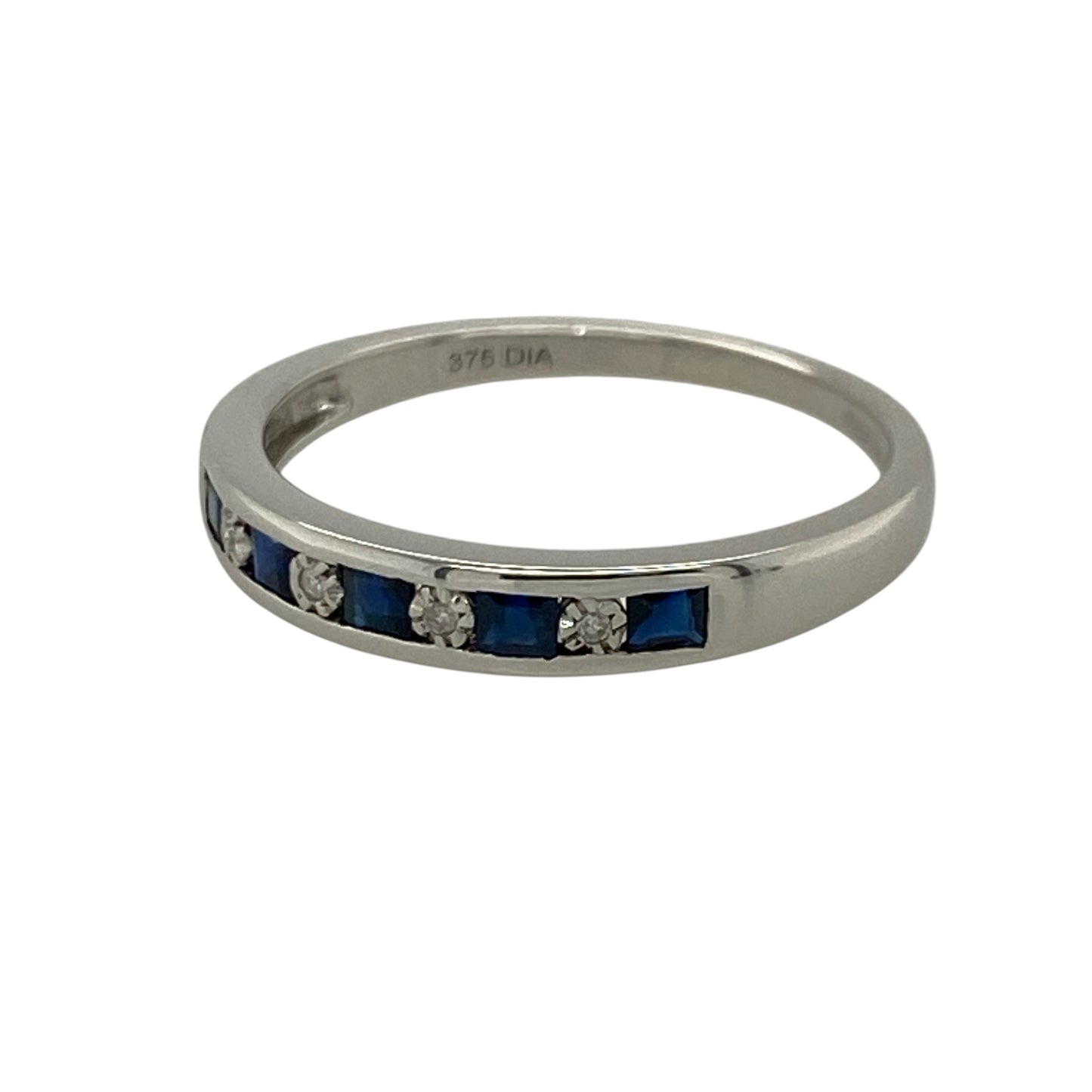 This pre-owned 9ct white gold diamond and sapphire band ring combines the timeless beauty of deep blue sapphires with sparkling brilliant cut diamonds in a sleek channel-set design.

Design: The ring features alternating square sapphires and brilliant cut diamonds, all securely channel set across the front of the band for a smooth, contemporary finish. The polished 9-carat white gold complements the gemstones beautifully, making it perfect for everyday wear or as a special occasion ring.