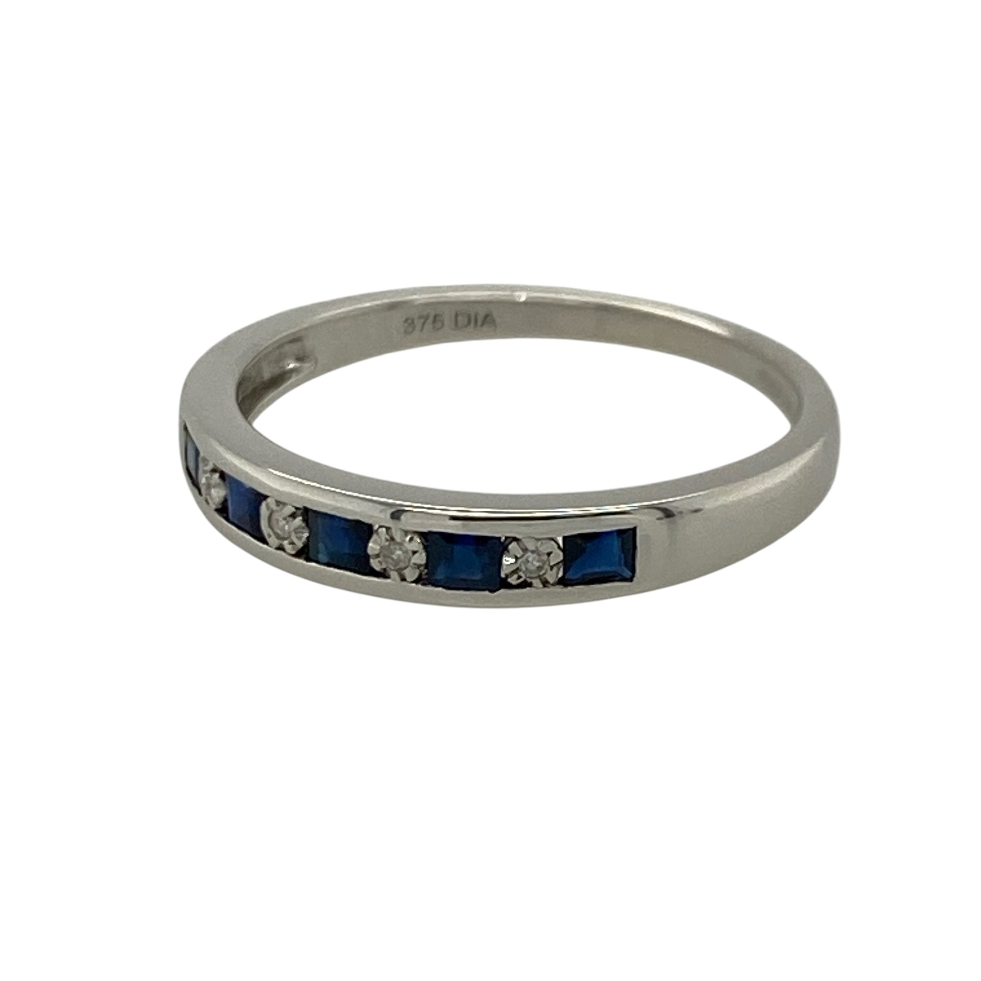 This pre-owned 9ct white gold diamond and sapphire band ring combines the timeless beauty of deep blue sapphires with sparkling brilliant cut diamonds in a sleek channel-set design.

Design: The ring features alternating square sapphires and brilliant cut diamonds, all securely channel set across the front of the band for a smooth, contemporary finish. The polished 9-carat white gold complements the gemstones beautifully, making it perfect for everyday wear or as a special occasion ring.