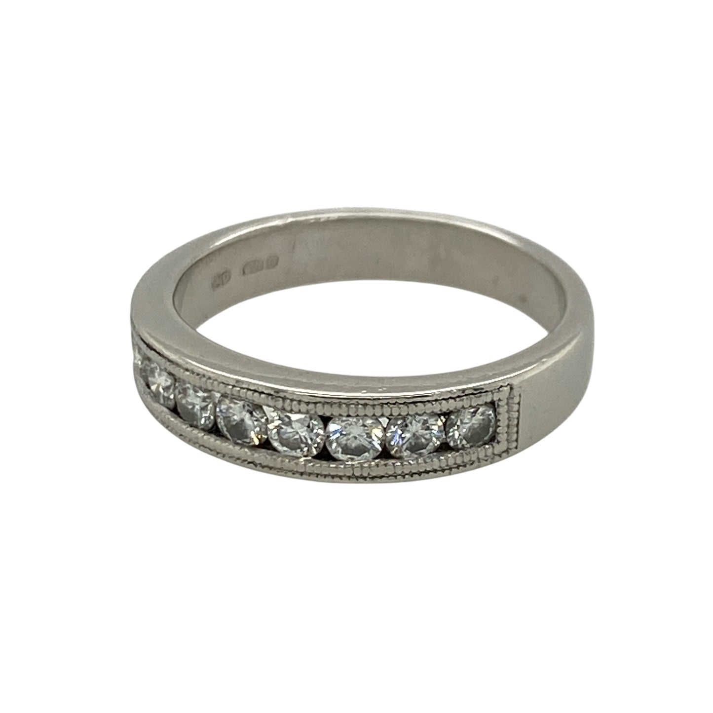 This pre-owned platinum diamond band ring combines timeless elegance with intricate milgrain detailing, making it a beautiful choice for everyday wear or as a wedding or anniversary band.

Design: The ring features a row of channel set diamonds across the front, complemented by delicate milgrain edge detailing that adds a vintage-inspired finish. The polished platinum setting enhances the brilliance of the diamonds while offering exceptional durability.
Material: Made from platinum.