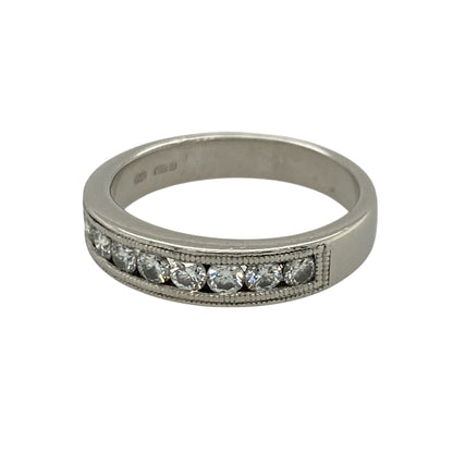 This pre-owned platinum diamond band ring combines timeless elegance with intricate milgrain detailing, making it a beautiful choice for everyday wear or as a wedding or anniversary band.

Design: The ring features a row of channel set diamonds across the front, complemented by delicate milgrain edge detailing that adds a vintage-inspired finish. The polished platinum setting enhances the brilliance of the diamonds while offering exceptional durability.
Material: Made from platinum.