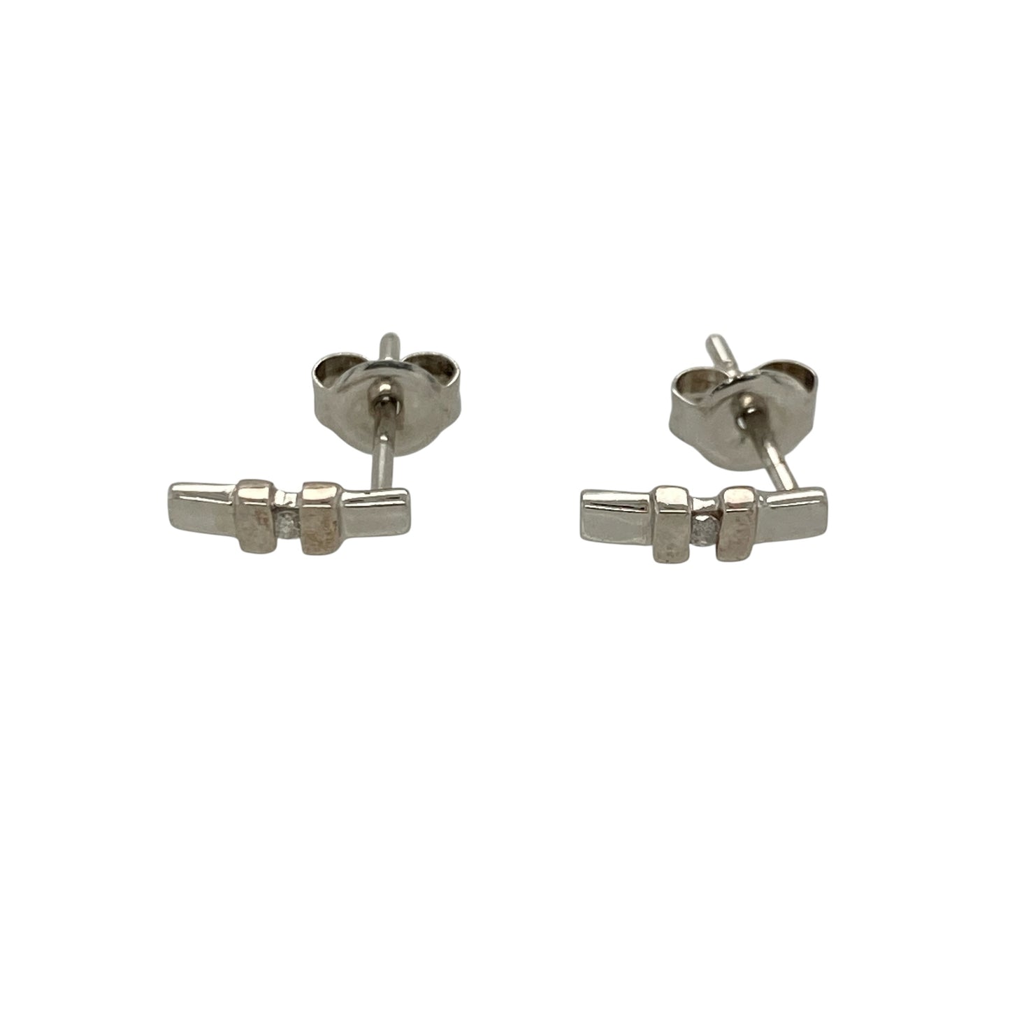 These pre-owned 9ct white gold diamond bar stud earrings offer a sleek and contemporary design, making them an elegant choice for everyday wear.

Design: Each stud features a slender bar design accented with sparkling diamonds, creating a modern and minimalist look. The polished 9-carat white gold setting enhances the brilliance of the diamonds while remaining lightweight and comfortable to wear.
Material: Made from 9-carat white gold.
Gemstone Detail: Set with sparkling diamonds along each bar.