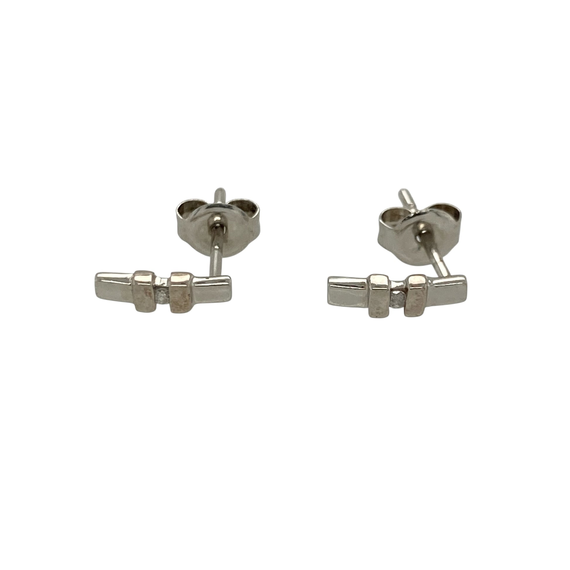 These pre-owned 9ct white gold diamond bar stud earrings offer a sleek and contemporary design, making them an elegant choice for everyday wear.

Design: Each stud features a slender bar design accented with sparkling diamonds, creating a modern and minimalist look. The polished 9-carat white gold setting enhances the brilliance of the diamonds while remaining lightweight and comfortable to wear.
Material: Made from 9-carat white gold.
Gemstone Detail: Set with sparkling diamonds along each bar.