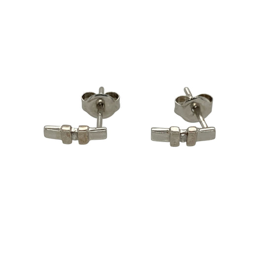 These pre-owned 9ct white gold diamond bar stud earrings offer a sleek and contemporary design, making them an elegant choice for everyday wear.

Design: Each stud features a slender bar design accented with sparkling diamonds, creating a modern and minimalist look. The polished 9-carat white gold setting enhances the brilliance of the diamonds while remaining lightweight and comfortable to wear.
Material: Made from 9-carat white gold.
Gemstone Detail: Set with sparkling diamonds along each bar.