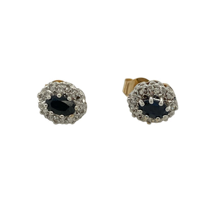 These pre-owned 9ct yellow gold diamond and sapphire cluster stud earrings combine rich blue sapphires with sparkling diamonds in a timeless cluster design.

Design: Each stud features an oval sapphire surrounded by a cluster of sparkling diamonds, creating a classic and elegant look. The warm yellow gold setting beautifully complements the deep blue sapphires, making these earrings perfect for both everyday wear and special occasions.
Material: Made from 9-carat yellow gold.