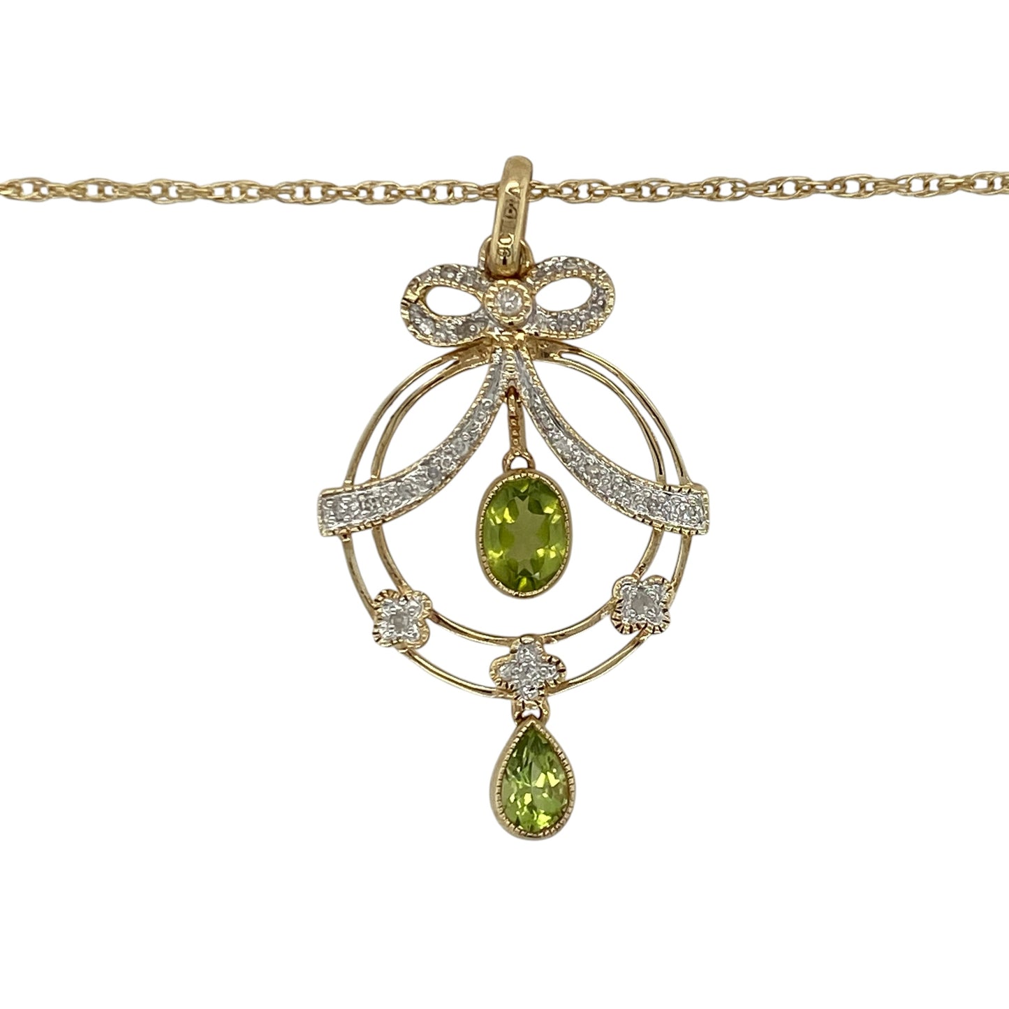 This pre-owned 9ct yellow and white gold diamond and peridot bow style pendant necklace combines elegant two-tone gold with vibrant peridot and sparkling diamonds in a graceful design.

Design: The necklace features a fancy bow style pendant crafted in yellow and white gold, set with a vibrant peridot and sparkling diamonds for a striking contrast. Suspended from a 16-inch Prince of Wales chain, the pendant measures approximately 4.1cm long including the bail, creating an elegant statement piece.