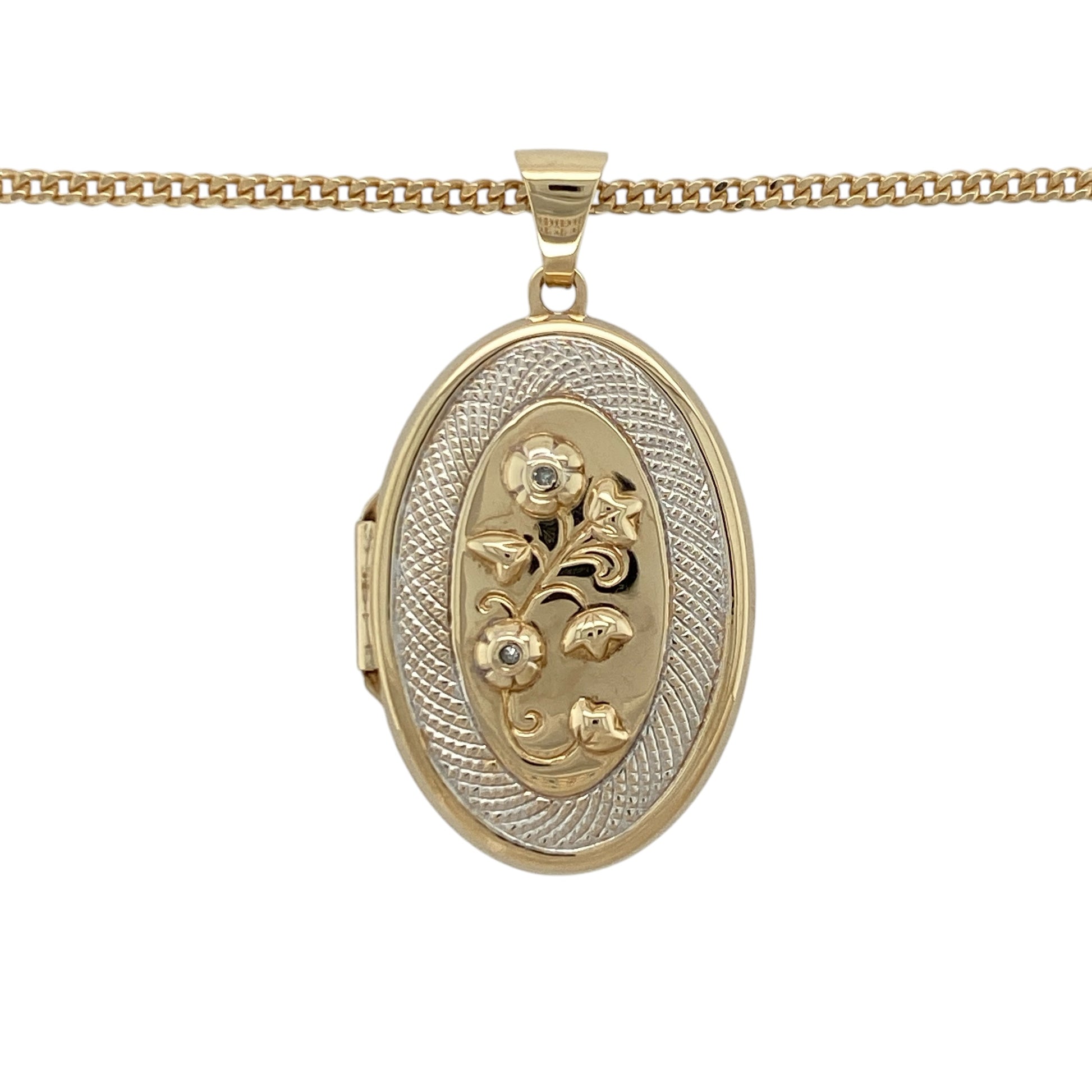 This pre-owned 9ct yellow and white gold diamond-set oval locket necklace features an elegant flower design with a textured surround, making it a timeless piece for everyday wear or special occasions.

Design: The oval locket showcases a beautiful flower motif highlighted with sparkling diamonds and framed by a textured surround in contrasting yellow and white gold. Suspended from a 20-inch curb chain, the pendant measures approximately 4.1cm long including the bail