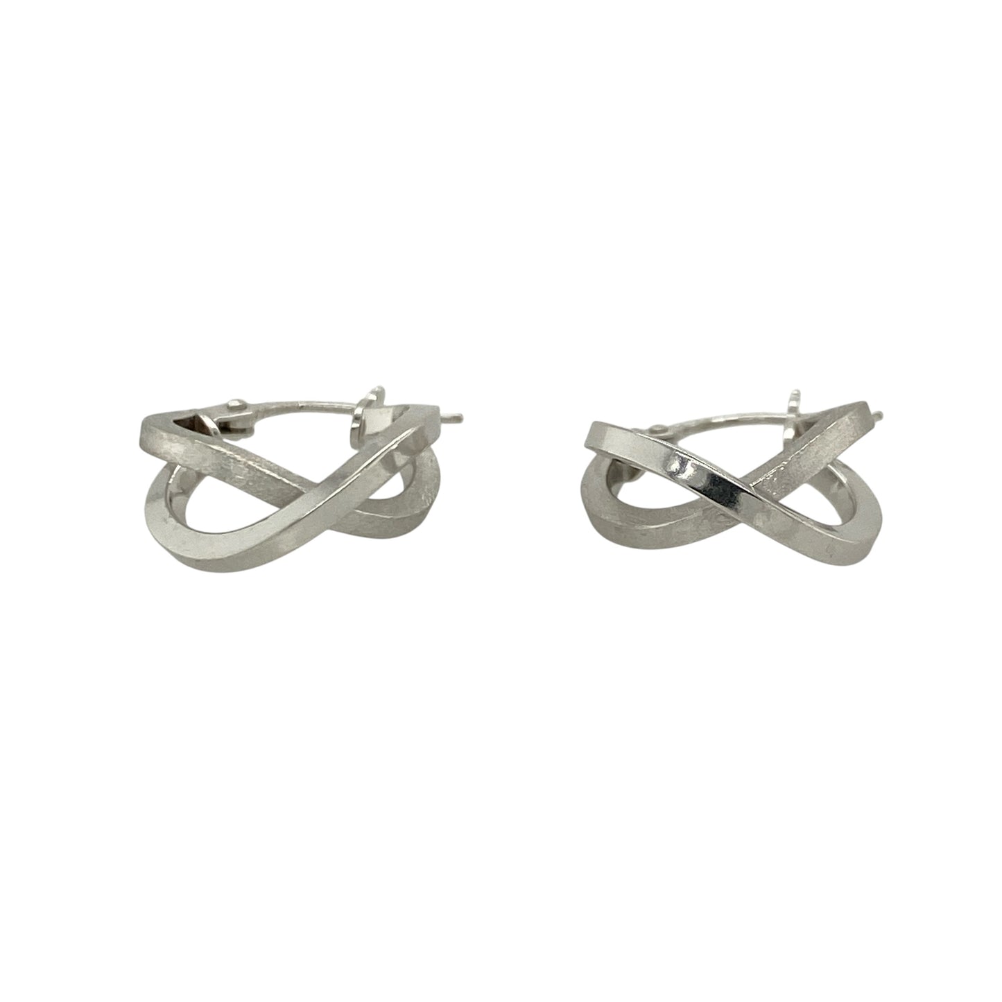 This pair of pre-owned 9ct white gold double hoop crossover creole earrings combines contrasting finishes with a modern crossover design.

Design: Featuring two interlocking hoops in a stylish crossover design, these creole earrings offer a contemporary look. One hoop has a polished finish while the other features a brushed effect, creating an attractive contrast that catches the light beautifully.
Material: Made from 9-carat white gold.