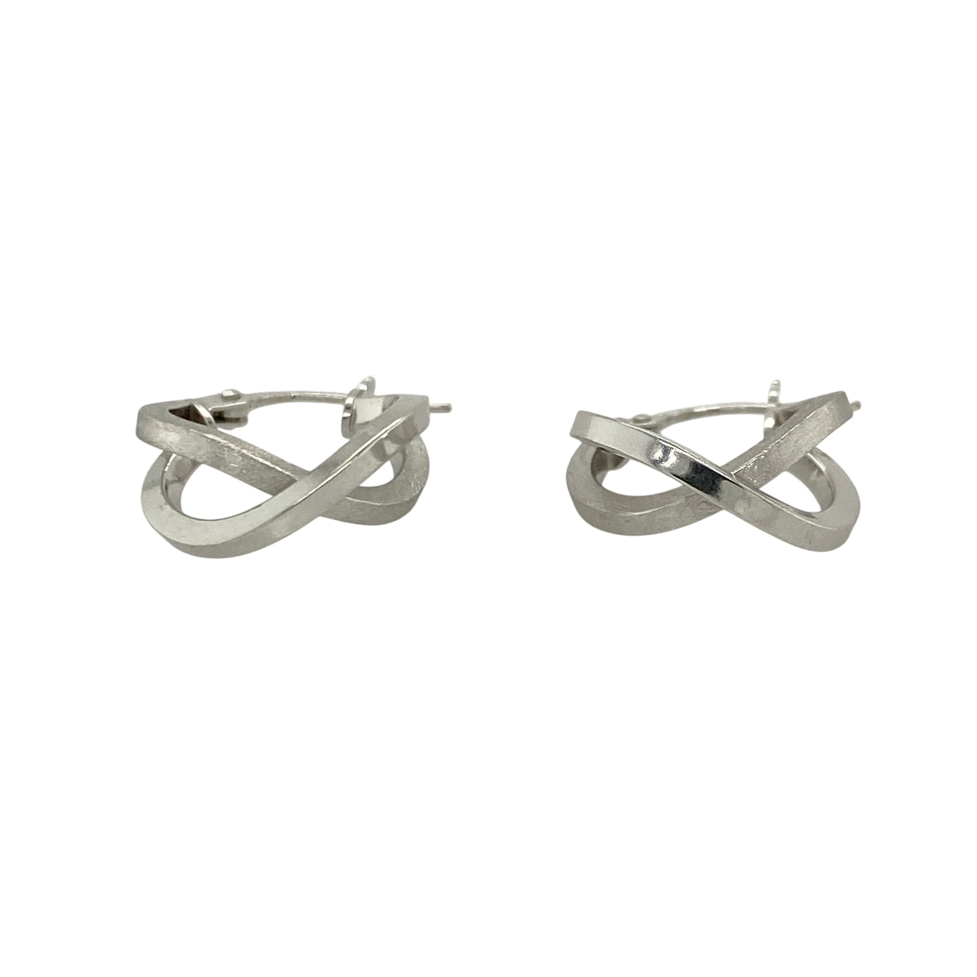 This pair of pre-owned 9ct white gold double hoop crossover creole earrings combines contrasting finishes with a modern crossover design.

Design: Featuring two interlocking hoops in a stylish crossover design, these creole earrings offer a contemporary look. One hoop has a polished finish while the other features a brushed effect, creating an attractive contrast that catches the light beautifully.
Material: Made from 9-carat white gold.