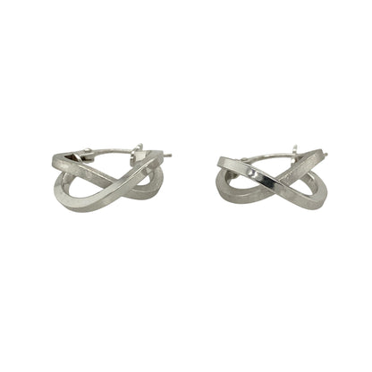 This pair of pre-owned 9ct white gold double hoop crossover creole earrings combines contrasting finishes with a modern crossover design.

Design: Featuring two interlocking hoops in a stylish crossover design, these creole earrings offer a contemporary look. One hoop has a polished finish while the other features a brushed effect, creating an attractive contrast that catches the light beautifully.
Material: Made from 9-carat white gold.