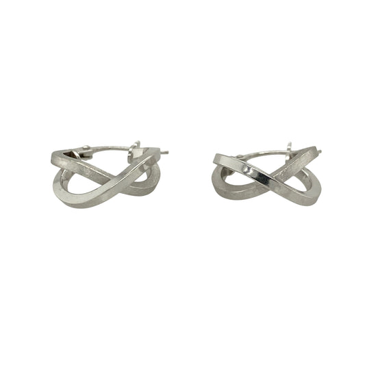 This pair of pre-owned 9ct white gold double hoop crossover creole earrings combines contrasting finishes with a modern crossover design.

Design: Featuring two interlocking hoops in a stylish crossover design, these creole earrings offer a contemporary look. One hoop has a polished finish while the other features a brushed effect, creating an attractive contrast that catches the light beautifully.
Material: Made from 9-carat white gold.