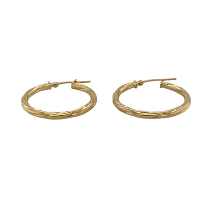 This pair of pre-owned 9ct yellow gold twisted hoop creole earrings features a timeless design with an elegant twisted finish.

Design: These hoop creole earrings showcase a classic twisted design that adds texture and catches the light beautifully. Their versatile style makes them perfect for everyday wear while being equally suited to dressing up for special occasions.
Material: Made from 9-carat yellow gold.
Earring Detail: Twisted hoop creole earrings with secure hinged fastenings.