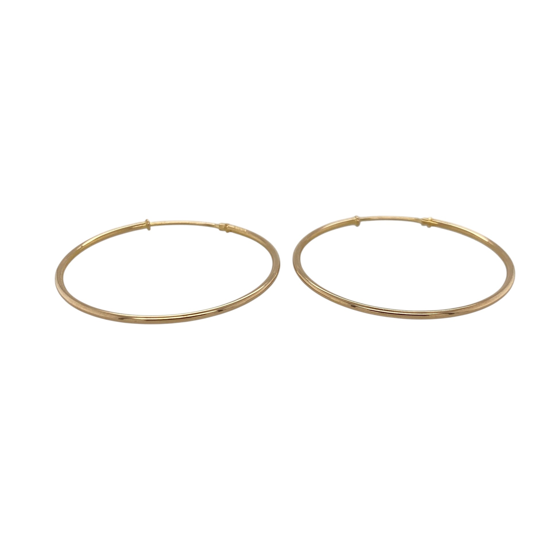This pair of pre-owned 9ct yellow gold plain hoop earrings offers a timeless design that complements any jewellery collection.

Design: These classic plain hoop earrings feature a smooth polished finish for a clean and versatile look. With a generous 35mm diameter, they are perfect for everyday wear while making a stylish statement.
Material: Made from 9-carat yellow gold.
Earring Detail: Plain hoop earrings with secure hinged fastenings.
Size & Weight: Hoop diameter approximately 35mm.