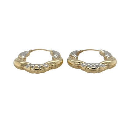 This pair of pre-owned 9ct yellow and white gold patterned twisted hoop creole earrings combines two-tone gold with an elegant twisted design.

Design: These eye-catching hoop creole earrings feature intertwined yellow and white gold with a decorative patterned finish, creating a striking two-tone look. Their 25mm diameter offers a versatile size that is ideal for both everyday wear and special occasions.
Material: Made from 9-carat yellow and white gold.