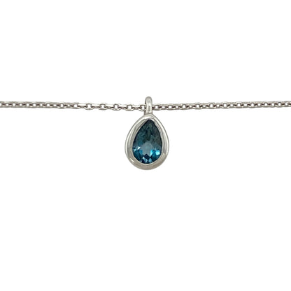 This pre-owned 14ct white gold blue topaz teardrop pendant necklace offers timeless elegance with the versatility of an adjustable chain.

Design: Suspended from an adjustable 16 to 18-inch trace chain, the graceful teardrop pendant showcases a beautiful blue topaz gemstone that adds a vibrant touch of colour. The adjustable length makes it easy to style with a variety of necklines, making it perfect for both everyday wear and special occasions.
Material: Made from 14-carat white gold.