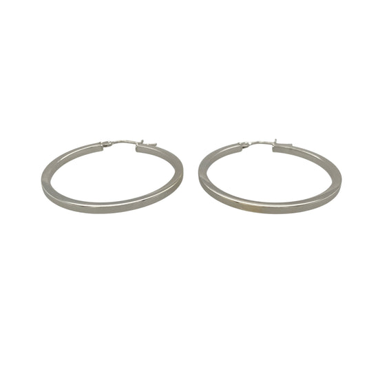This pair of pre-owned 9ct white gold plain hoop creole earrings offers a timeless design that is perfect for everyday wear.

Design: Featuring a classic polished hoop design, these creole earrings are both versatile and stylish. Their 33mm diameter creates an elegant look that can be worn on their own or paired with other jewellery for any occasion.
Material: Made from 9-carat white gold.
Earring Detail: Plain hoop creole earrings measuring approximately 33mm in diameter with secure hinged fastenings.