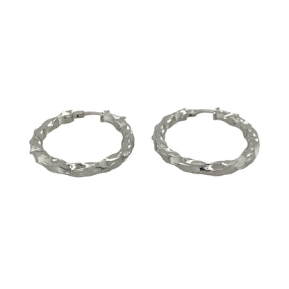 This pair of pre-owned 9ct white gold twisted oval creole earrings offers a stylish twist on a timeless jewellery classic.

Design: Featuring an elegant oval hoop shape with a twisted finish, these creole earrings catch the light beautifully while adding subtle texture and interest. Their versatile design makes them ideal for everyday wear as well as special occasions.
Material: Made from 9-carat white gold.
Earring Detail: Twisted oval creole earrings with secure hinged fastenings.
