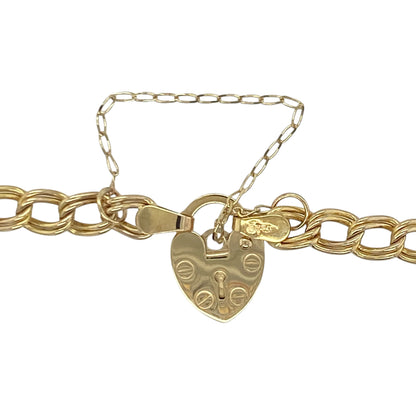 This pre-owned 9ct yellow gold double curb bracelet is a timeless piece featuring a classic heart padlock clasp and safety chain.

Design: Featuring traditional double curb links, this elegant bracelet is finished with a heart-shaped padlock clasp and a safety chain for added security. Its classic design has remained a favourite for generations, making it a beautiful piece for everyday wear or special occasions.
Material: Made from 9-carat yellow gold.